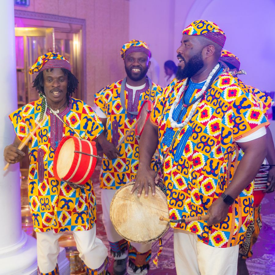 Drummers performing in kente at the ball